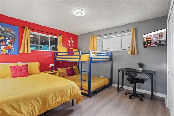 Versatile Comfort for All  – Our room boasts a queen-sized bed, a double-sized bunk bed with a desk and chair for work or study, and a smart TV for your leisure.