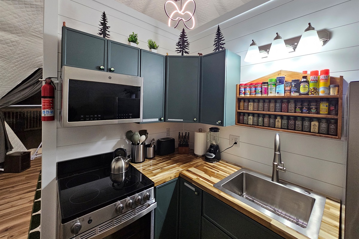 A thoughtfully stocked kitchenette for cozy meals in