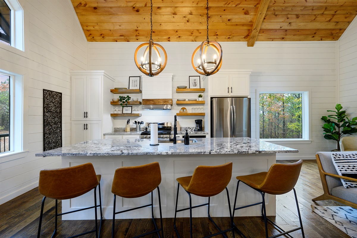 Kitchen island moments made for coffee chats and second helpings. 
Bright, cozy, and wrapped in warm cabin charm, this is where slow mornings and memory making naturally begin.