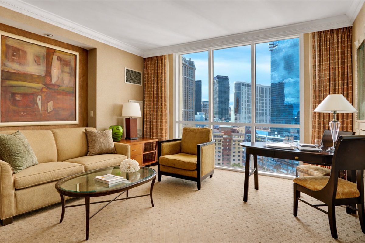 Unwind in the stylish living area with floor-to-ceiling windows showcasing the city.