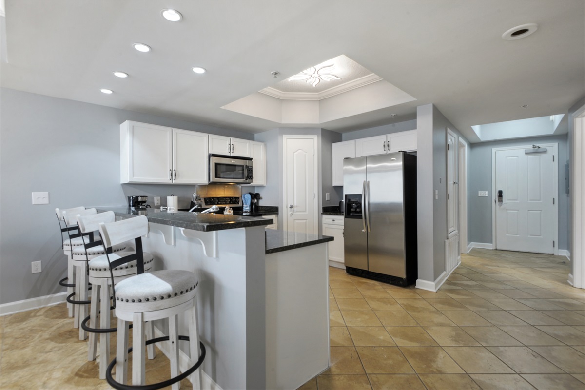 Kitchen looking down hallway at front door.