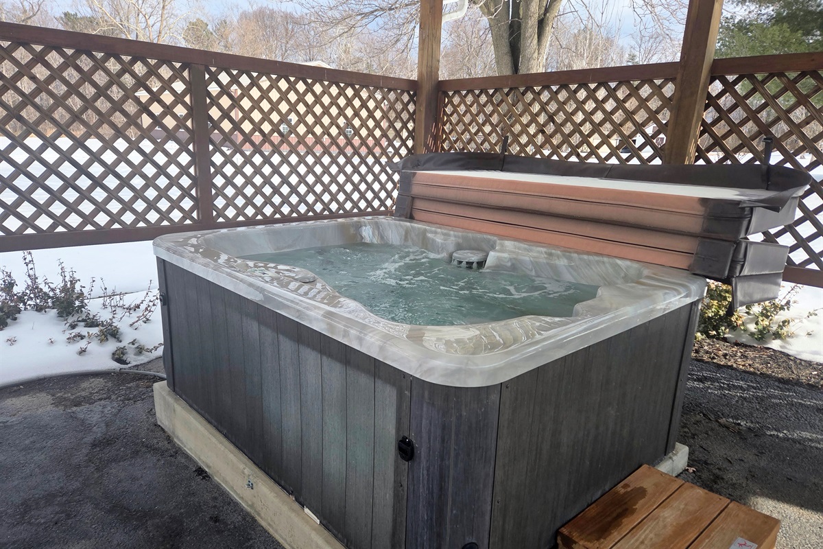 Relax in the bubbling hot tub with peaceful views and the calming sounds of nature
