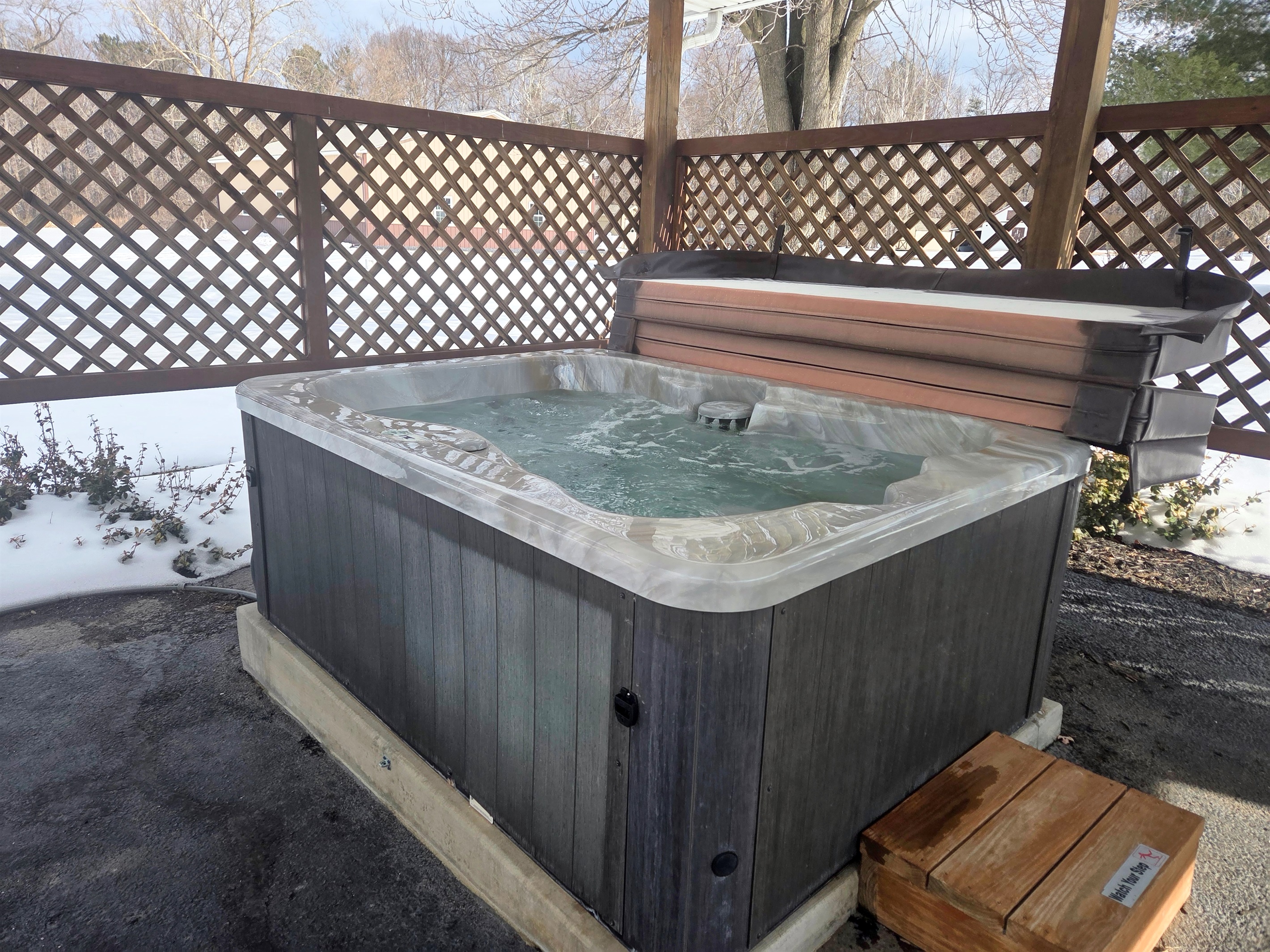 Relax in the bubbling hot tub with peaceful views and the calming sounds of nature