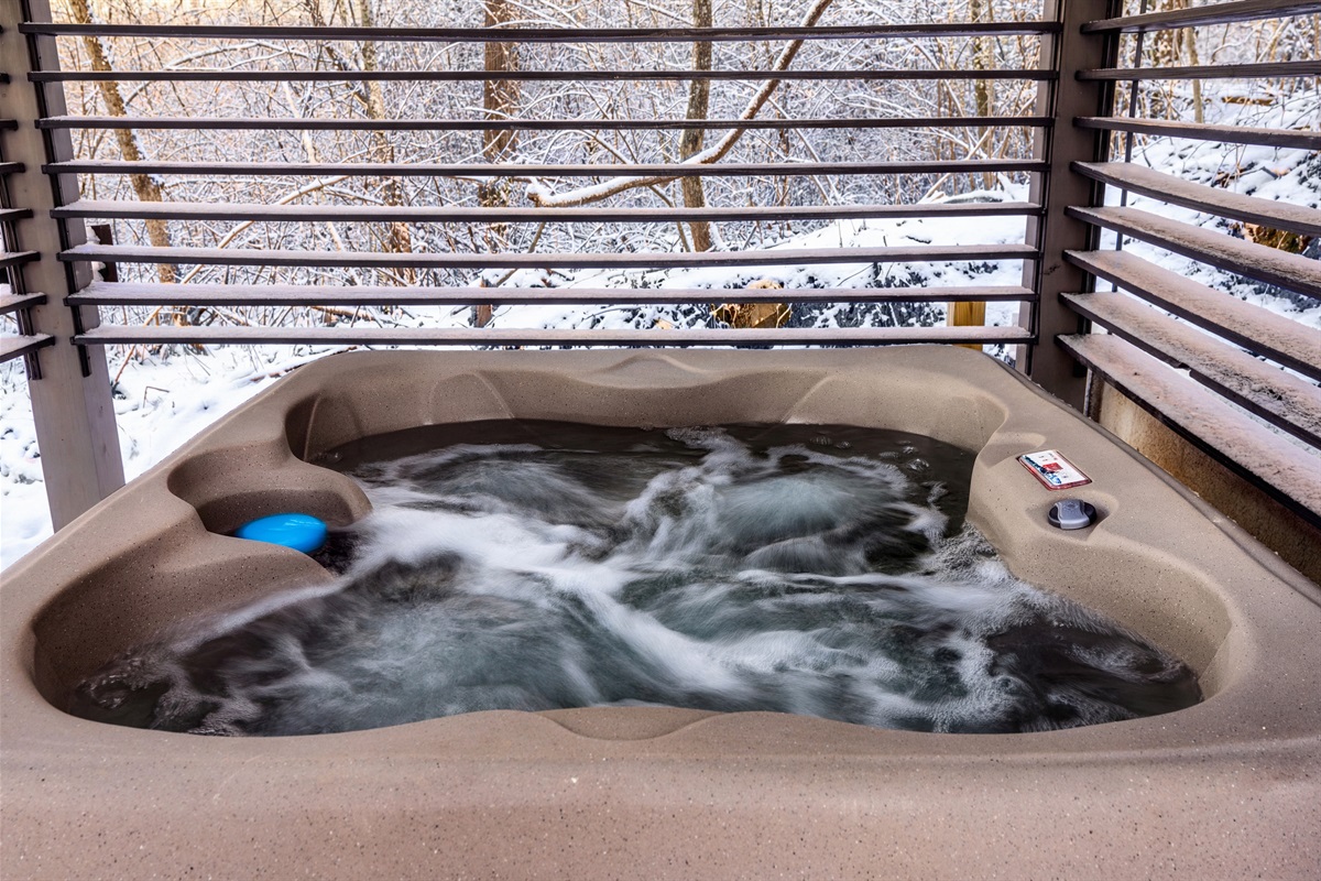 Hot tub with adjustable wooden side slats that close for privacy & decrease wind flow.