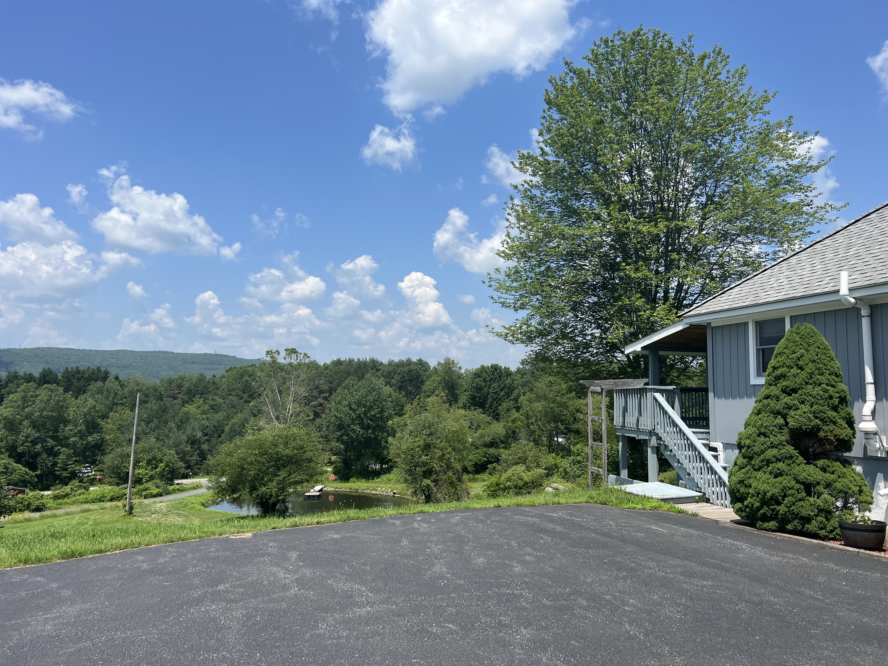 Exterior of Shagbark Hill with long distance views and the private pond can be seen below.