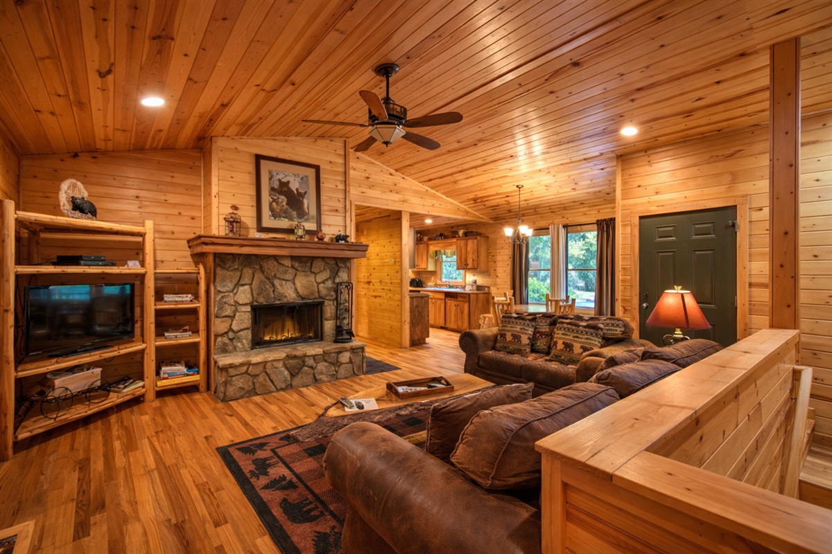 Cozy cabin living at its finest—warm wood interiors, a stone fireplace, and the perfect space to unwind after a day in the mountains.