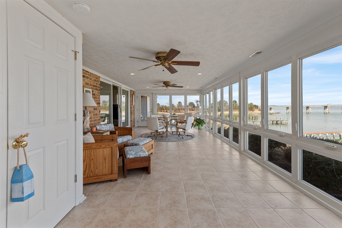 Sunroom Oasis: Enjoy stunning water views while relaxing in this bright, airy space!
