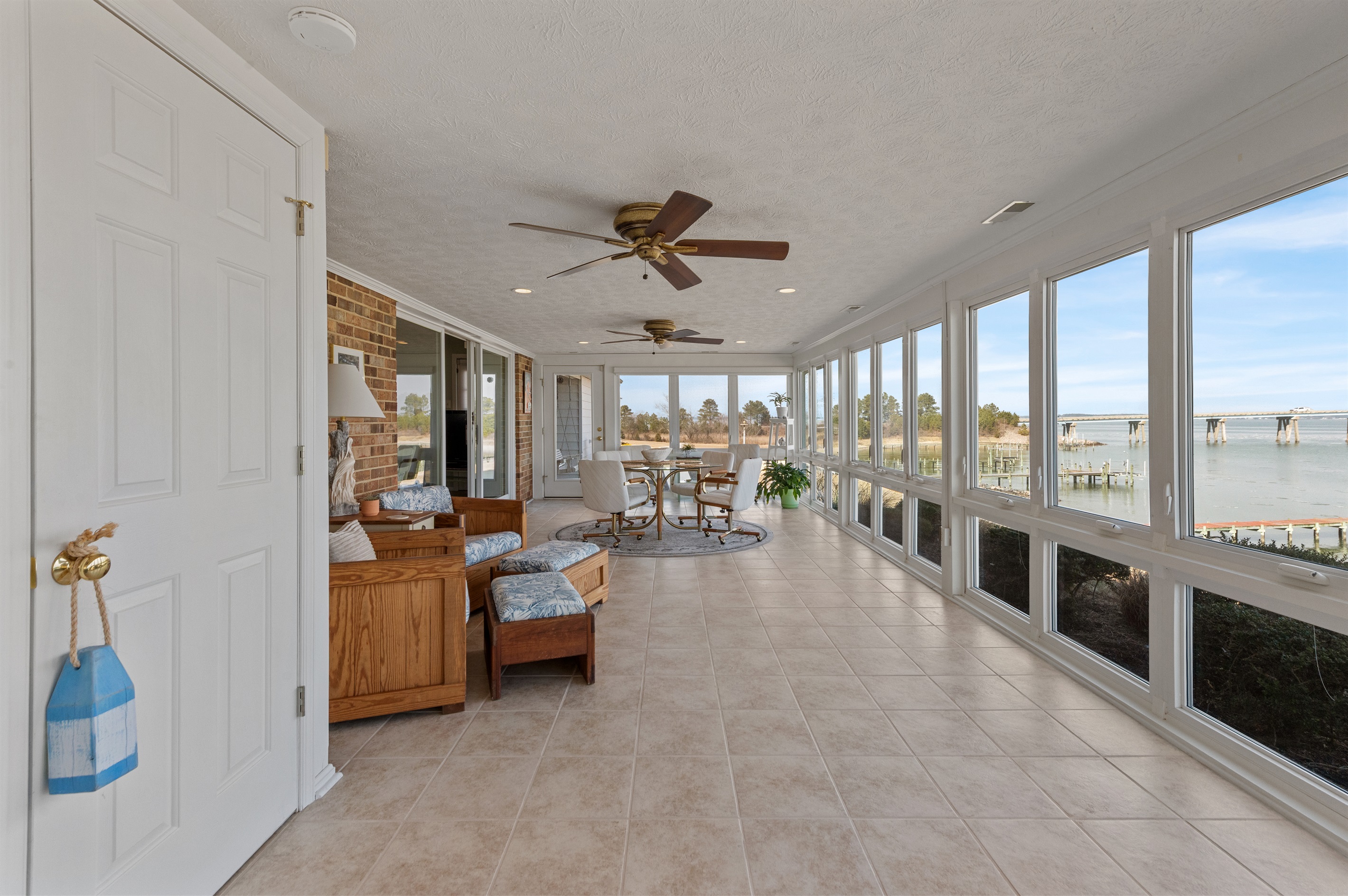Sunroom Oasis: Enjoy stunning water views while relaxing in this bright, airy space!