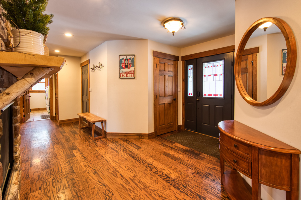 Welcome home! A warm Adirondack entryway welcomes you with beautiful hardwood floors and rustic charm.