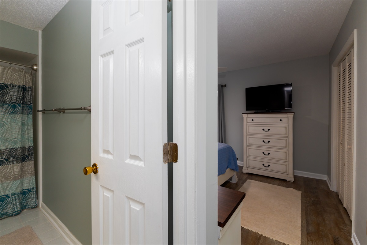 Room with TV, bed, and cabinetry