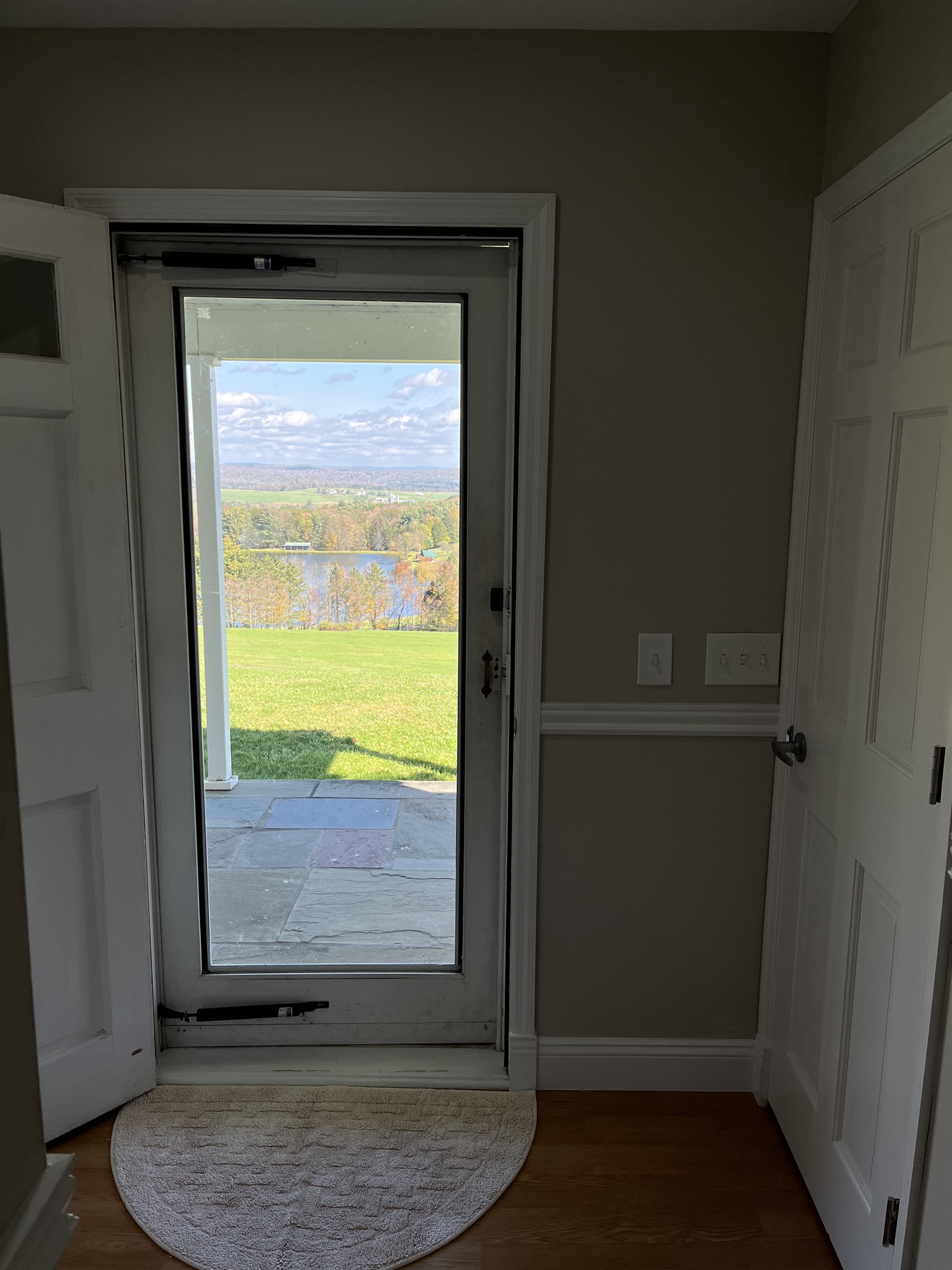 Hilltop Hideaway front door looking onto the massive front lawn.