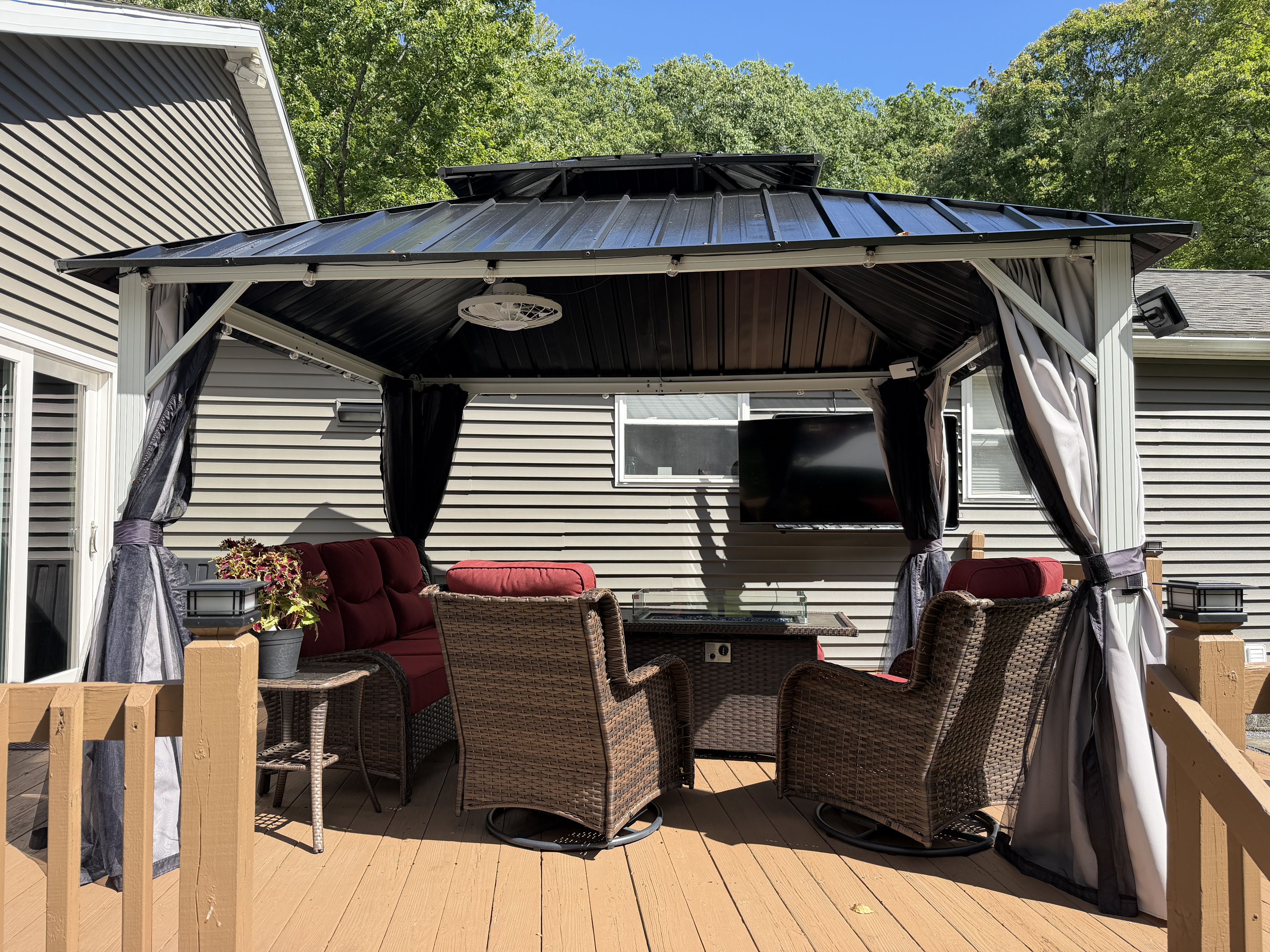 Back porch seating with outdoor SmartTV and gas fire tabel