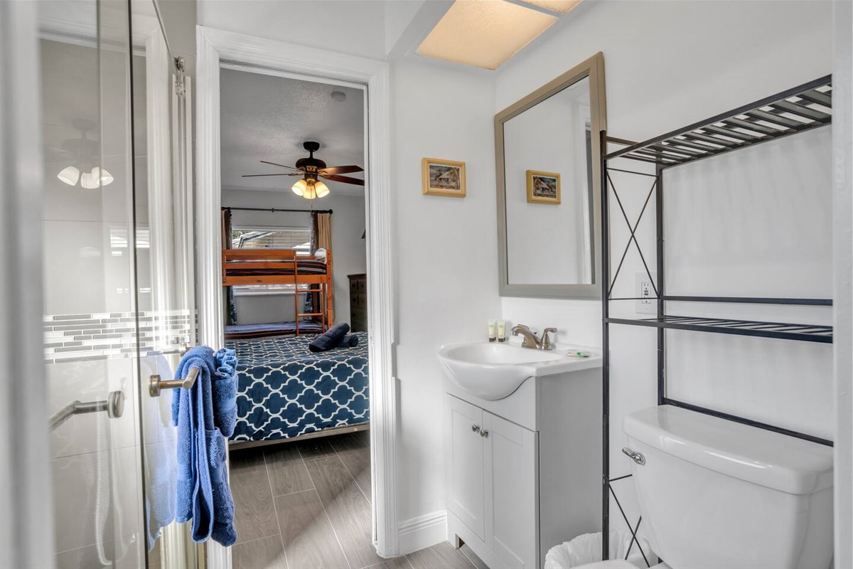 Bathroom with shower, looking into the bunkbed room