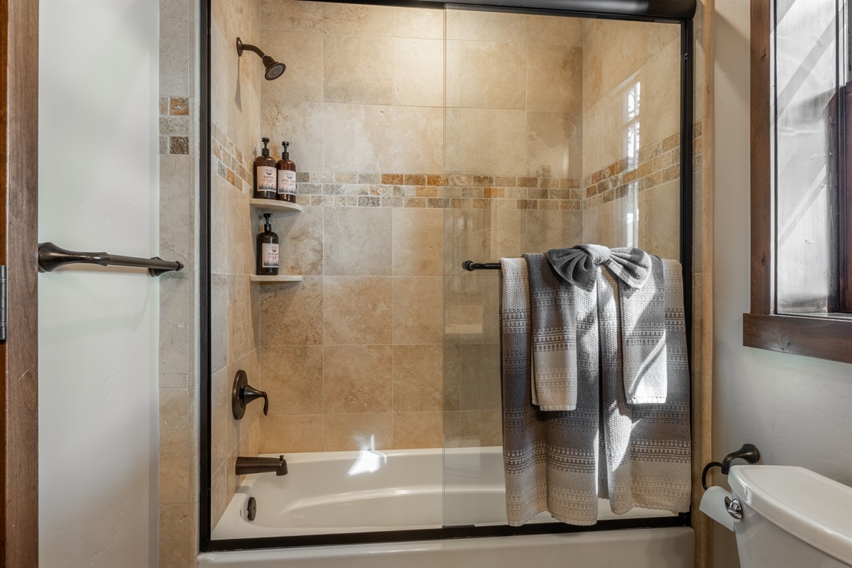 This main-floor bath serves the bunkroom and gathering spaces offers a practical tub/shower combo for rinsing off after skiing or outdoor adventures.