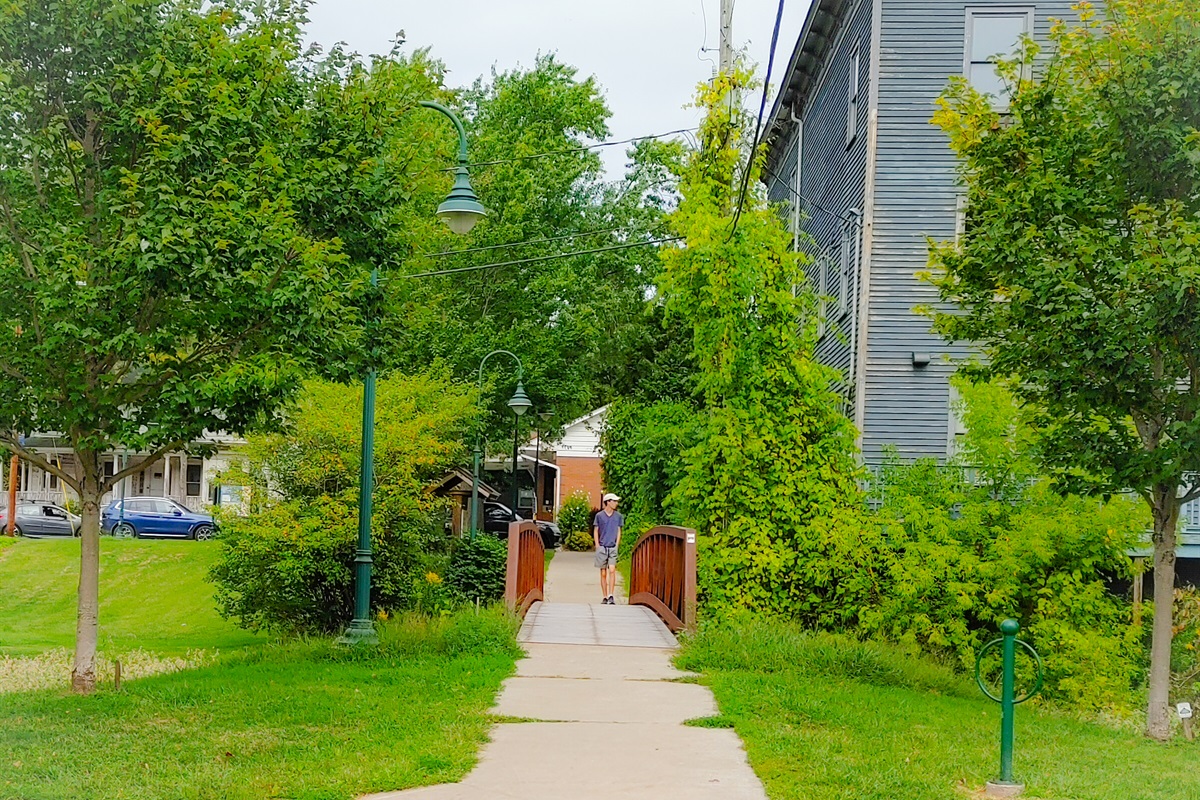 Walkover Bridge located behind the building in the free Municipal Parking lot.