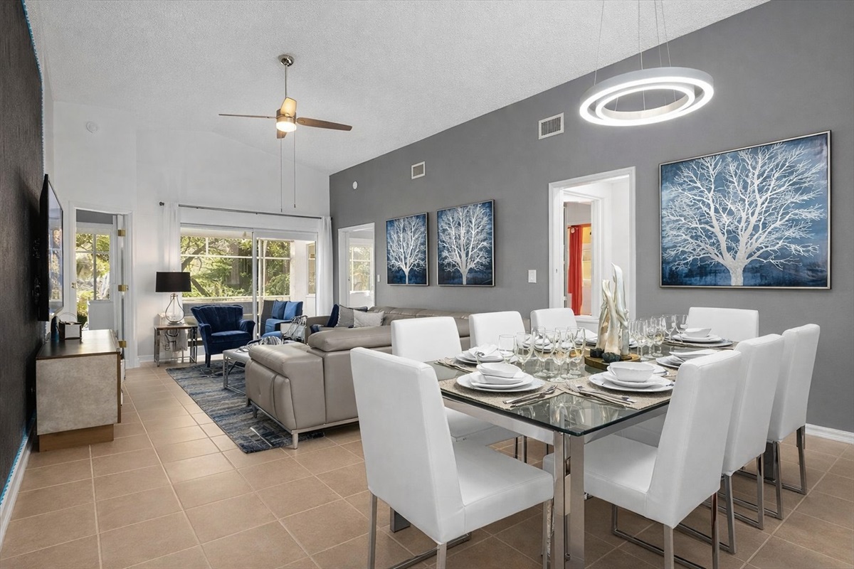 Open-concept living and dining area with plenty of light and contemporary artwork.