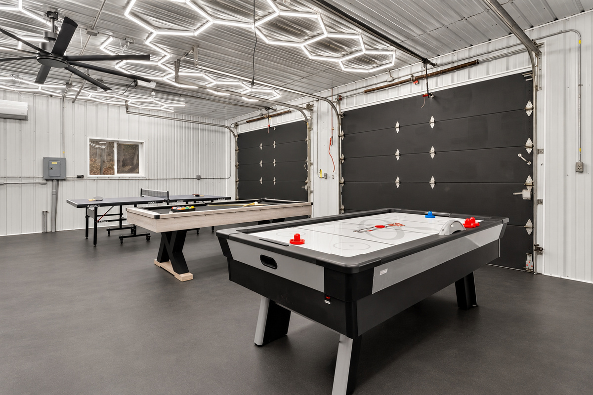 Pool table beneath geometric ceiling lights