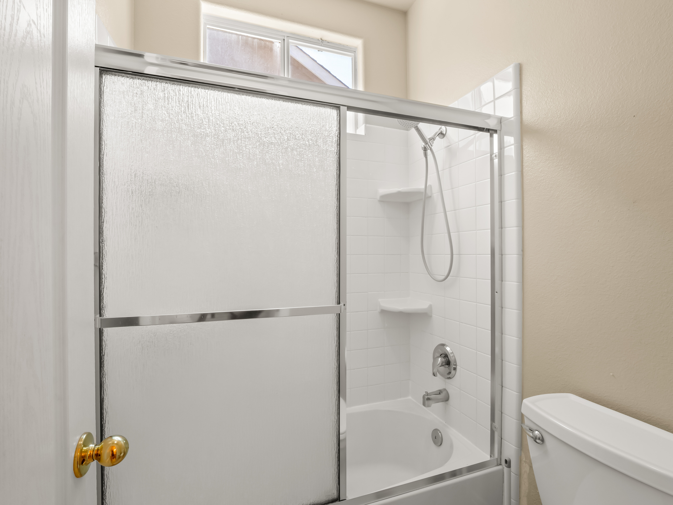 Refresh and recharge in this bright, clean bathroom featuring a shower/tub combination and plenty of natural light. Perfect for a relaxing soak after a day of work, sightseeing, or family adventures.