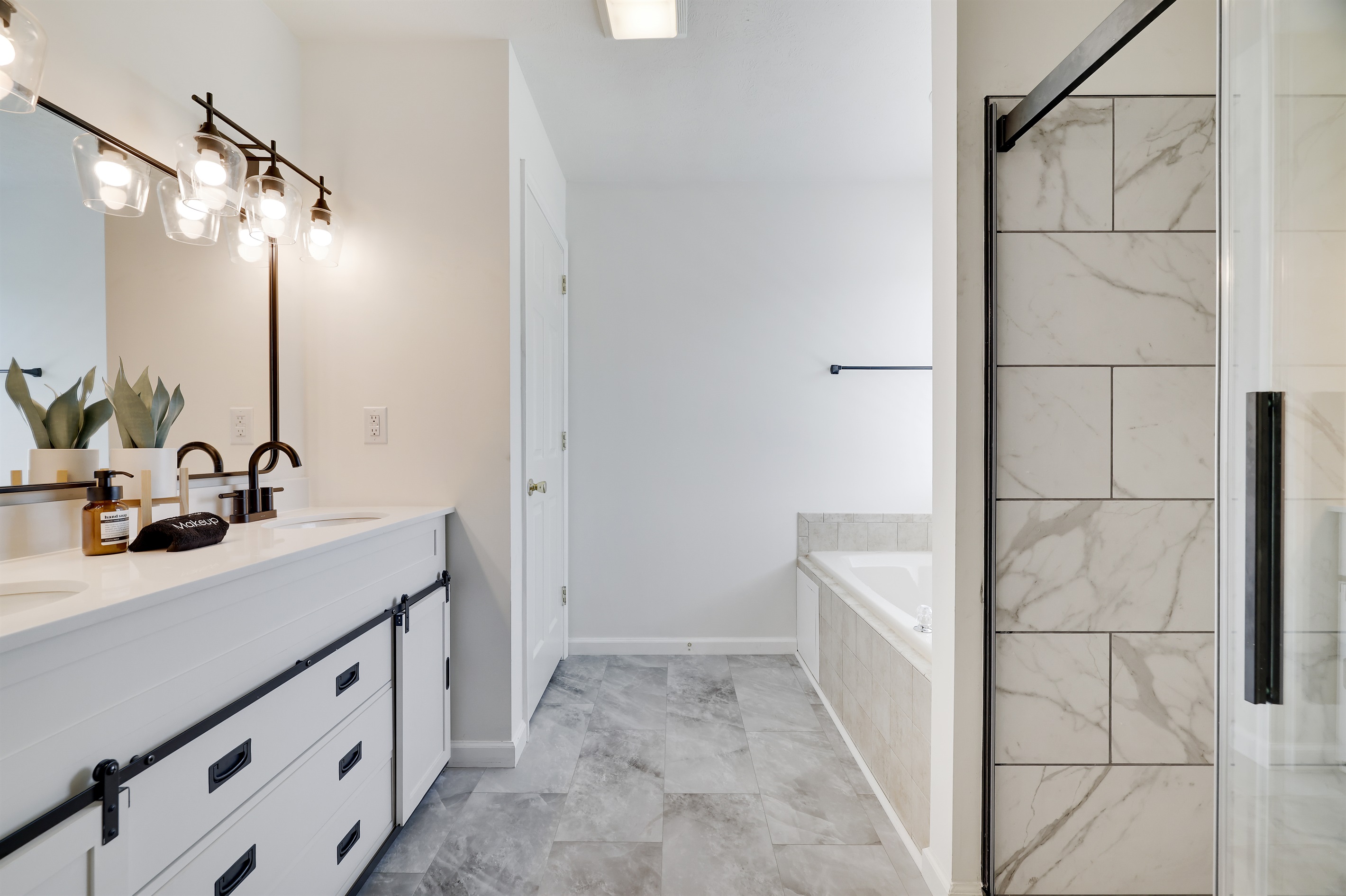 The inviting master bathroom has a jacuzzi tub and a separate walk-in shower.