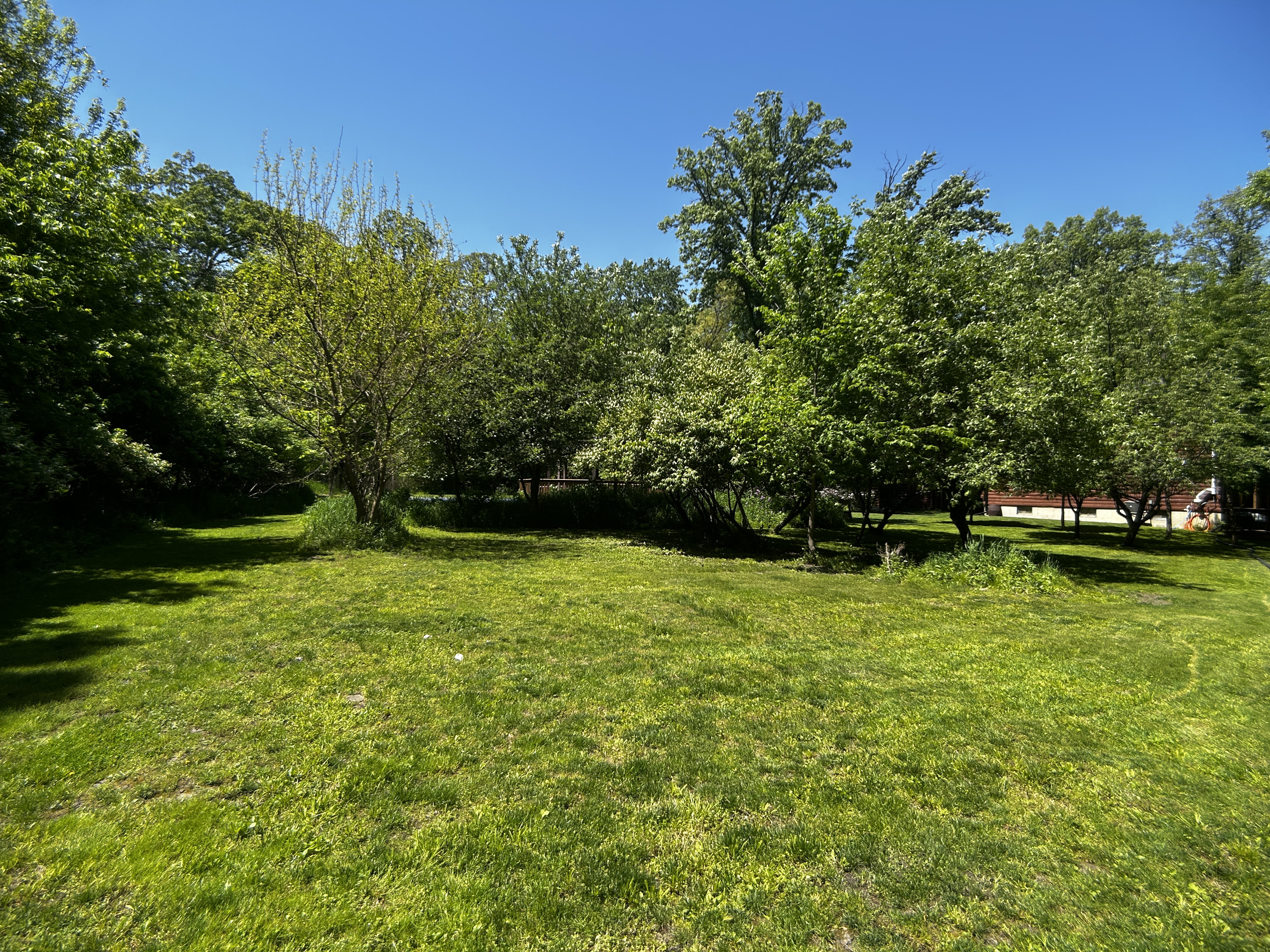 The gazebo and pickleball court are behind the grassy berm.