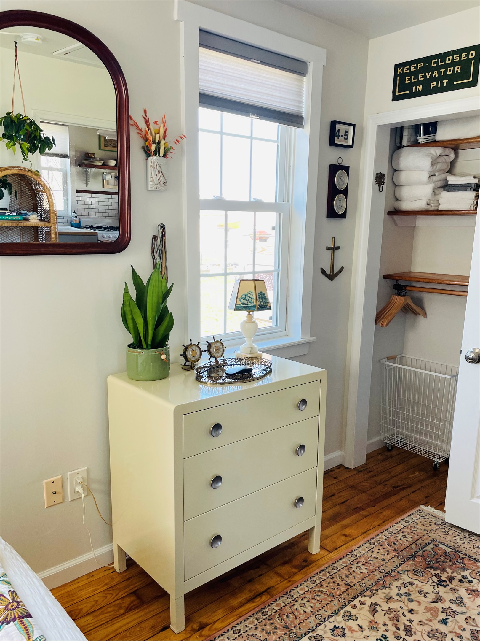 Chest of drawers, closet in bedroom. 