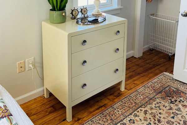 Chest of drawers, closet in bedroom. 