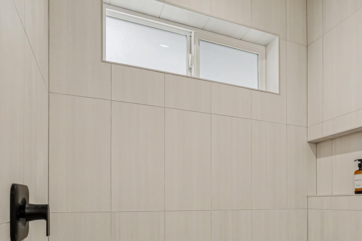 Enjoy a spacious open-concept walk-in shower designed with modern comfort in mind.