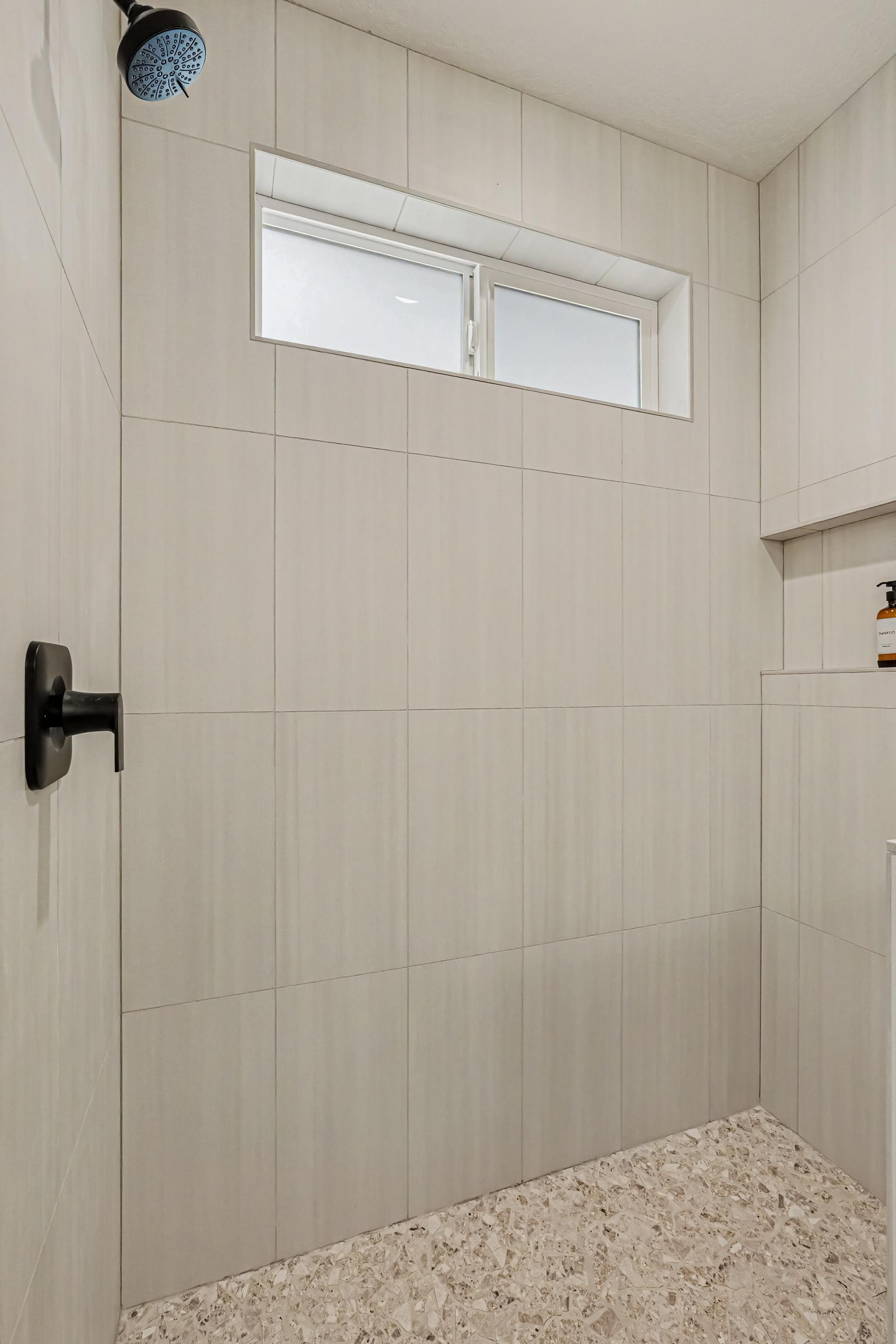 Enjoy a spacious open-concept walk-in shower designed with modern comfort in mind.