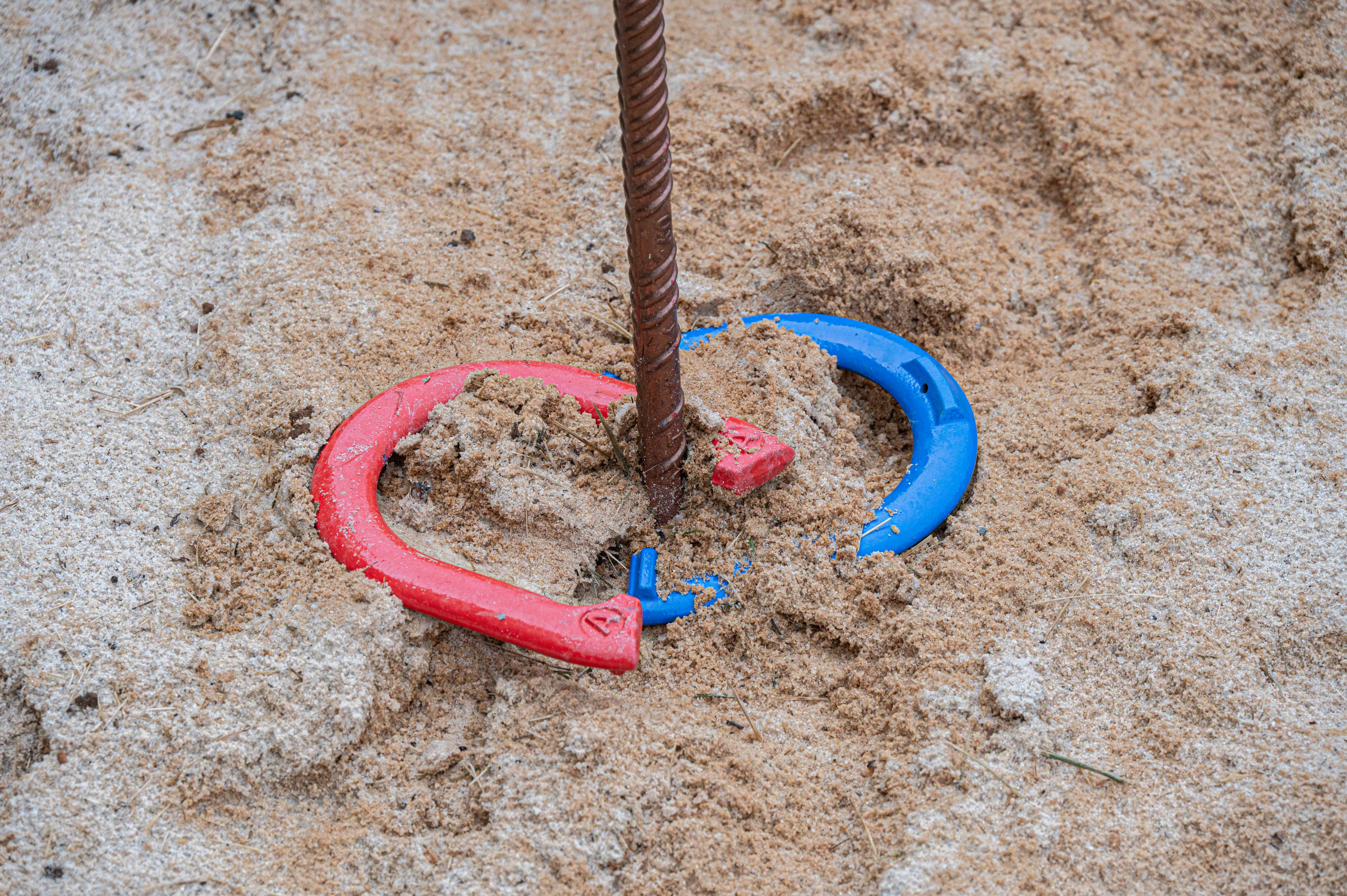 Fun Outdoor Games: Enjoy friendly competitions with horseshoes in the sunny sand!