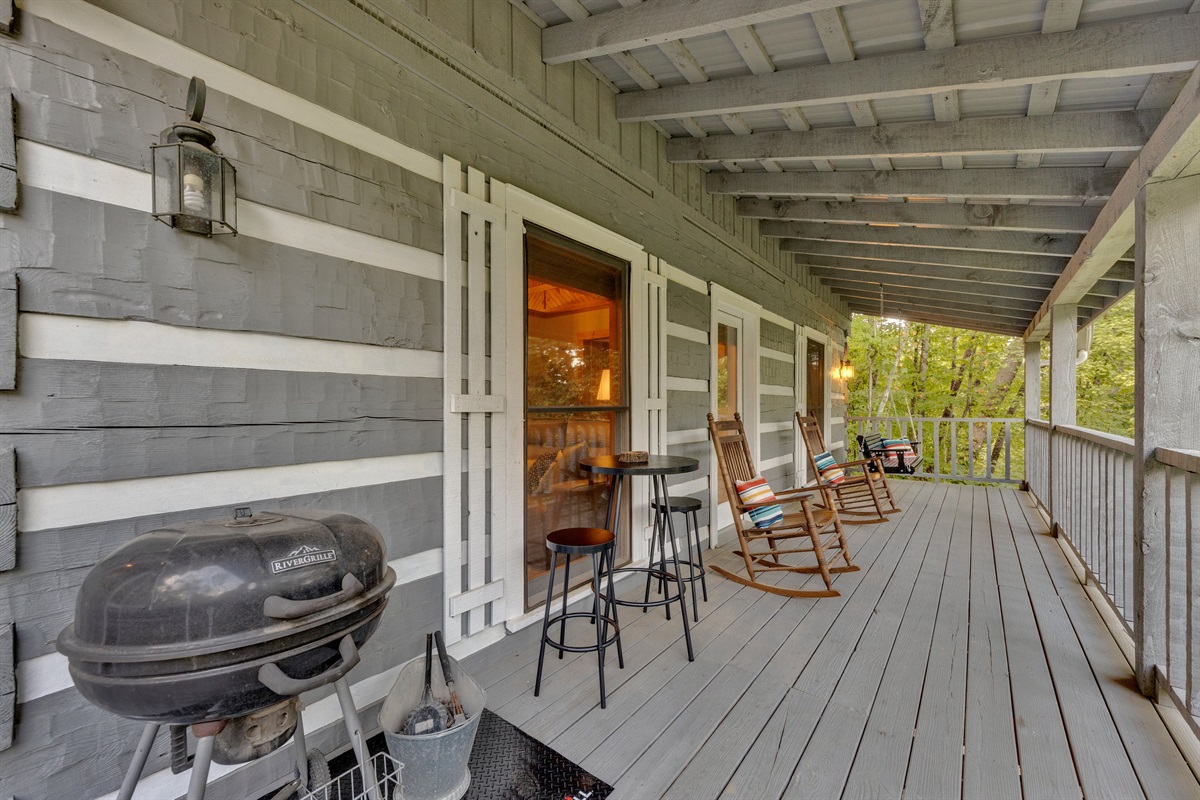 The back deck offers plenty of seating plus a charcoal grill for outdoor meals