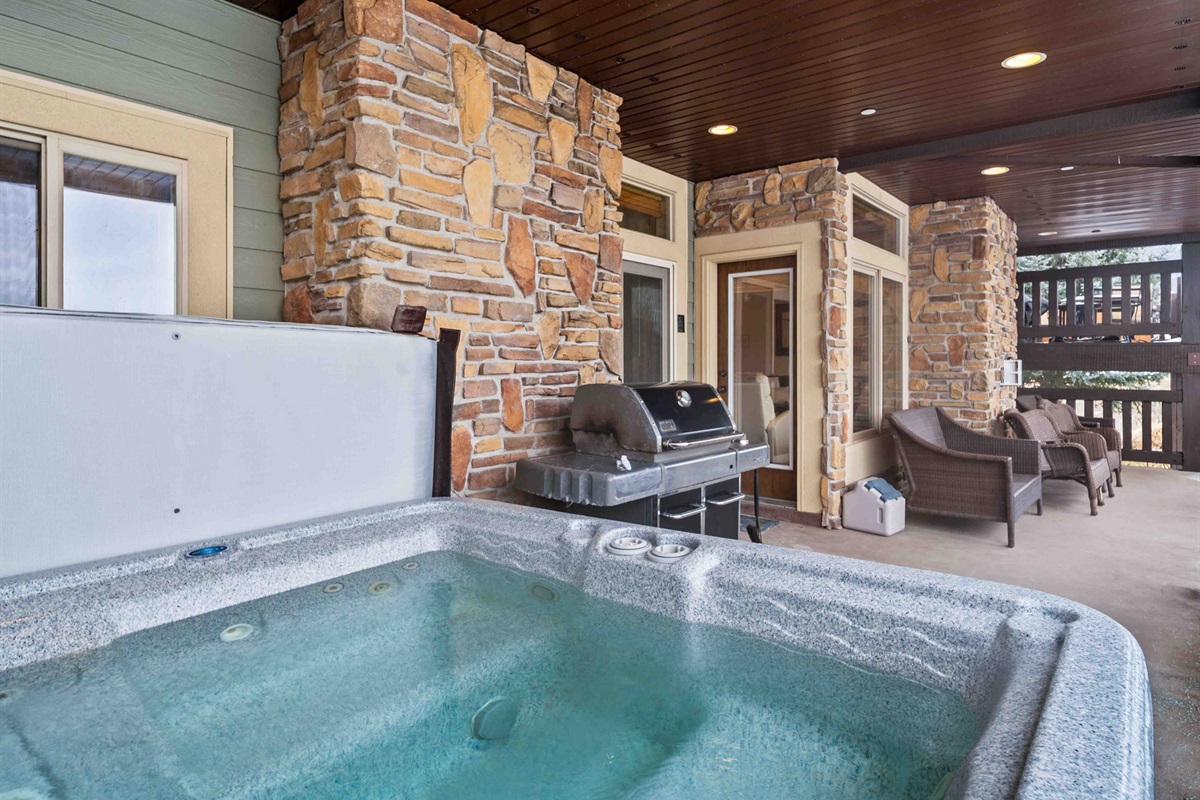 Private hot tub, BBQ grill, and outdoor seating for year-round relaxation.