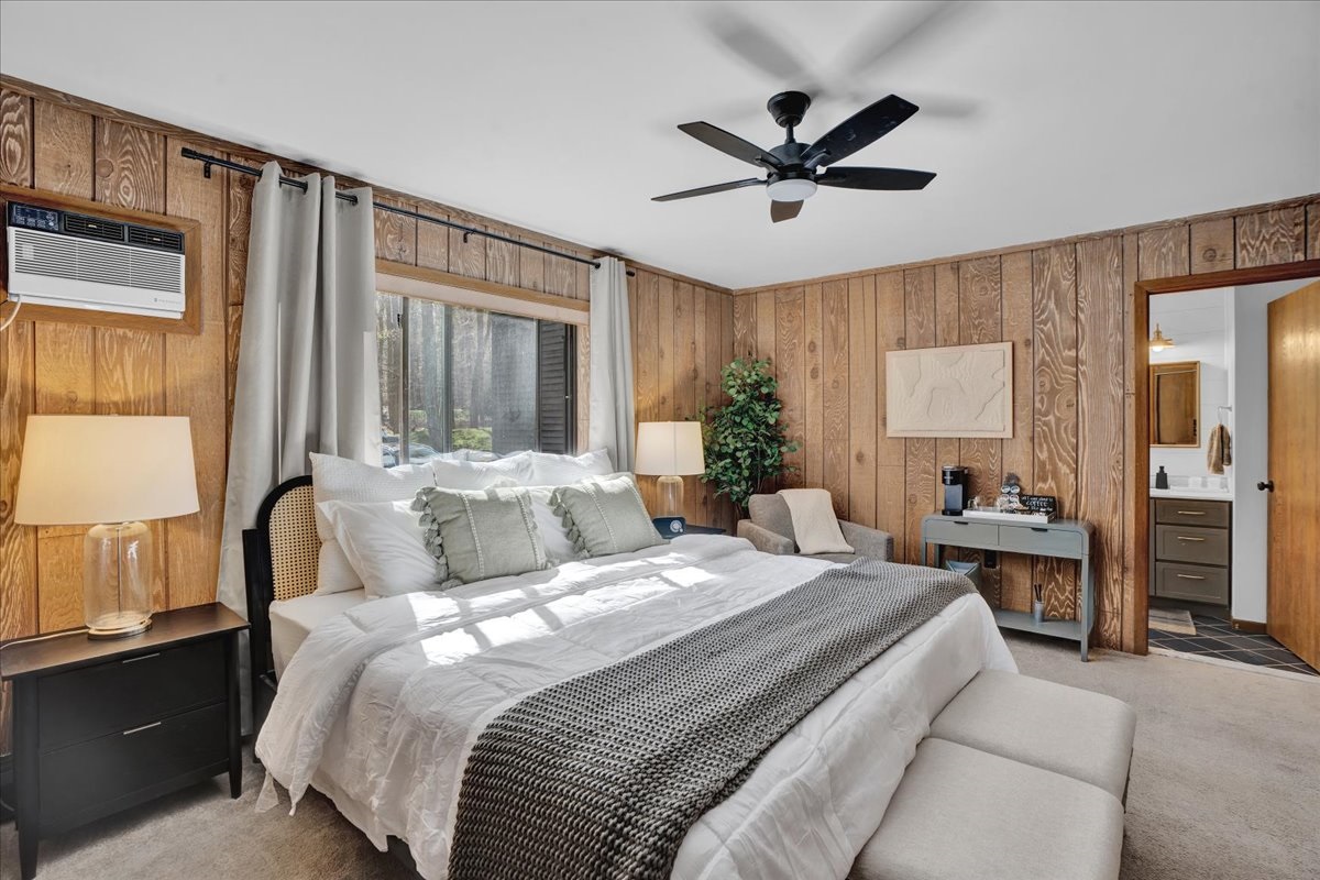 “Master suite with king bed, reading chair, air purifier, and forest view.”