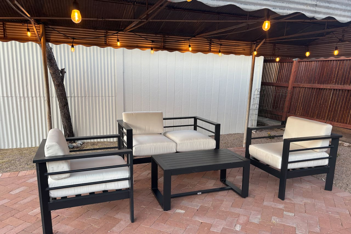 Outdoor sitting area under shade structure with outdoor lights