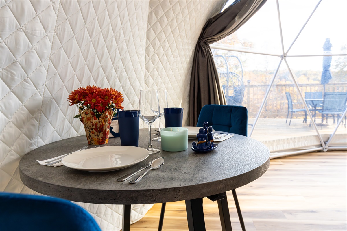 Cozy dining nook for two with lake views—perfect for slow breakfasts, romantic dinners, and morning coffee in your private dome.