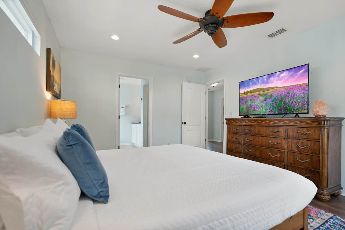 Warm light, a big comfortable bed and a television for slow mornings. The upstairs bedrooms sit well away from the pool and the lounge, so the early sleepers are not at the mercy of the late ones below.