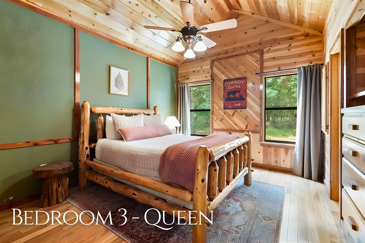 Cozy cabin charm carries through into the third queen bedroom.