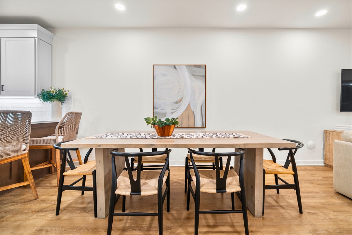 Bright, open dining room connected to kitchen and living area.