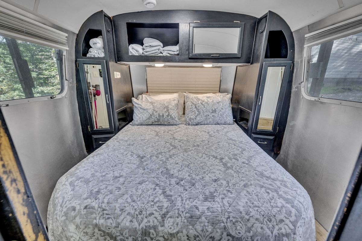 Cozy sleeping space tucked into the vintage Airstream interior