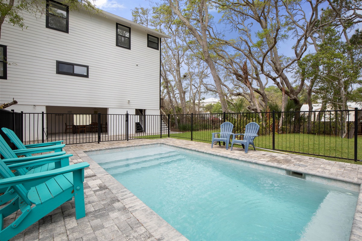 Mornings start with coffee by the pool and quiet shade from the trees, while the kids count down to their first splash. By afternoon, the whole family is drifting between swims, sunshine, and easy conversation in a backyard made for staying longer.