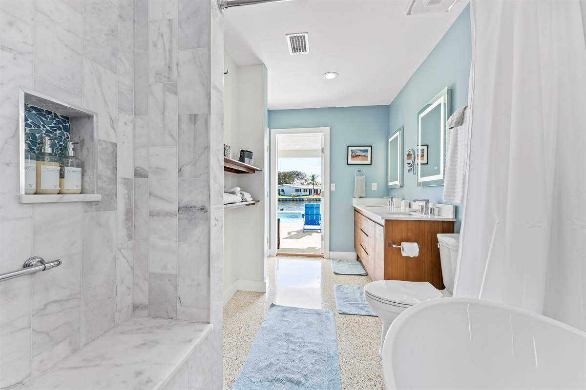 En suite bathroom in the Sunset Suite Primary Bedroom also has a door to the pool area