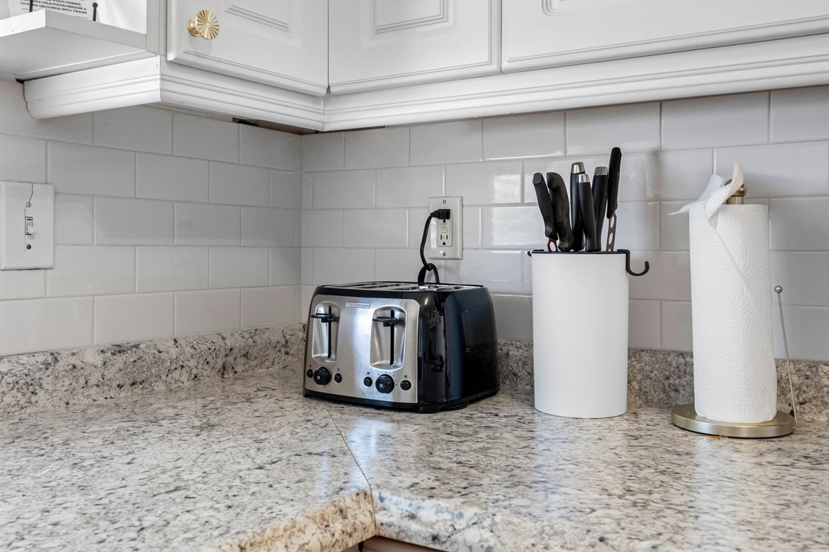 A modern-meets-cozy kitchen space with polished granite surfaces, subway tile backsplash, and updated appliances that make cooking a joy.