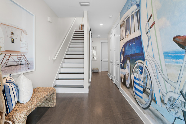Feel the beach vibes the moment you arrive! Our inviting entryway features a beautiful coastal mural and charming bench, creating the perfect welcome and setting the tone for a relaxing 30A getaway.
