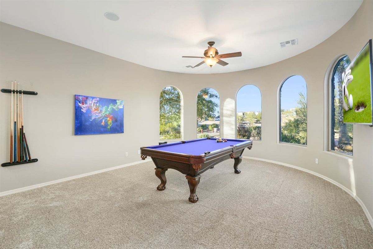 Enjoy games and entertainment with a wall-mounted TV positioned perfectly for viewing while playing pool.