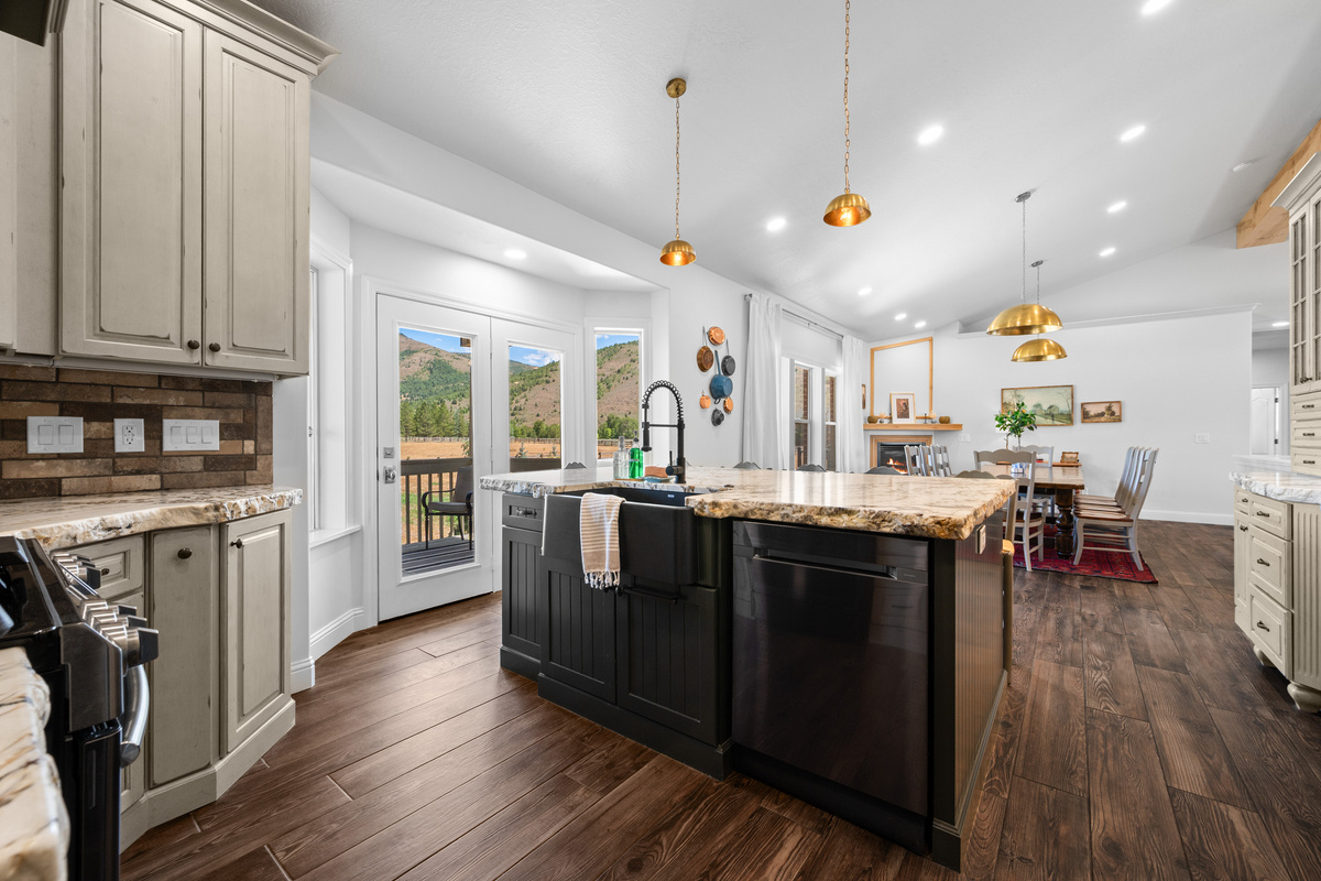 An open layout connects the kitchen, dining area, and outdoor access, making it easy for guests to cook, dine, and gather without feeling separated.