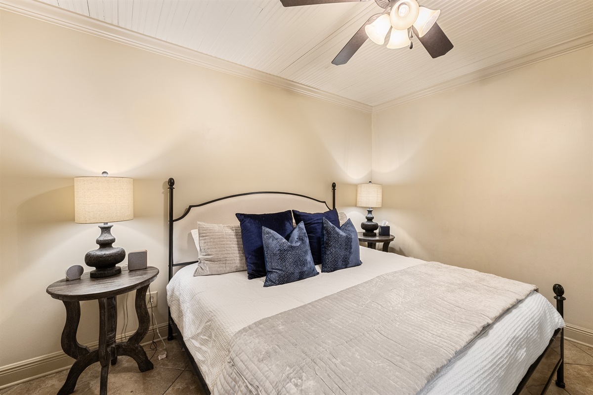 Elegant king bed with plush pillows and stylish decor for a restful escape