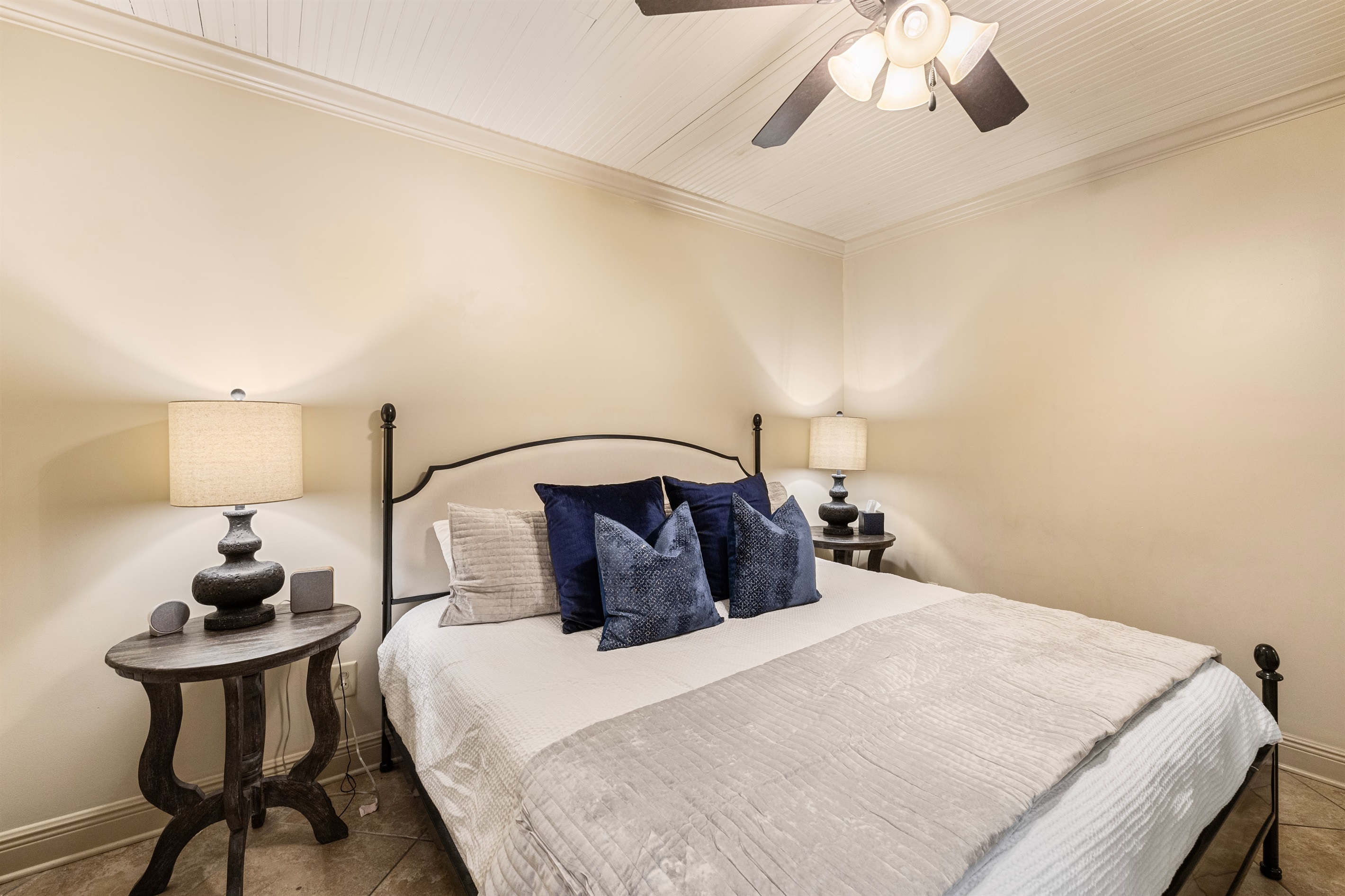 Elegant king bed with plush pillows and stylish decor for a restful escape