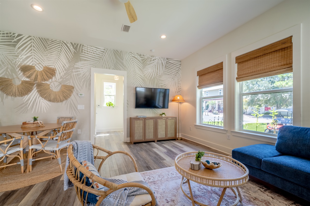 The spacious living room features a Smart TV and a comfortable dining table.