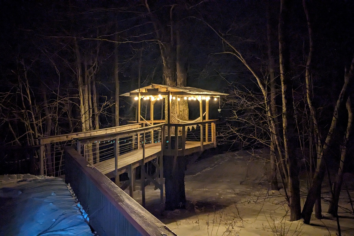 Treehouse deck night view with string lights