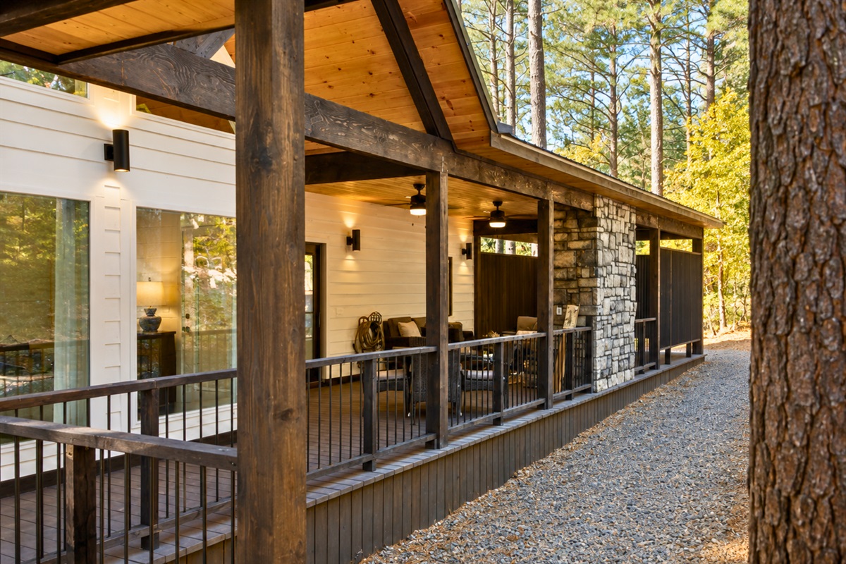 The spacious wraparound deck offers plenty of cozy corners to relax, reconnect, and enjoy the beauty of Broken Bow together.