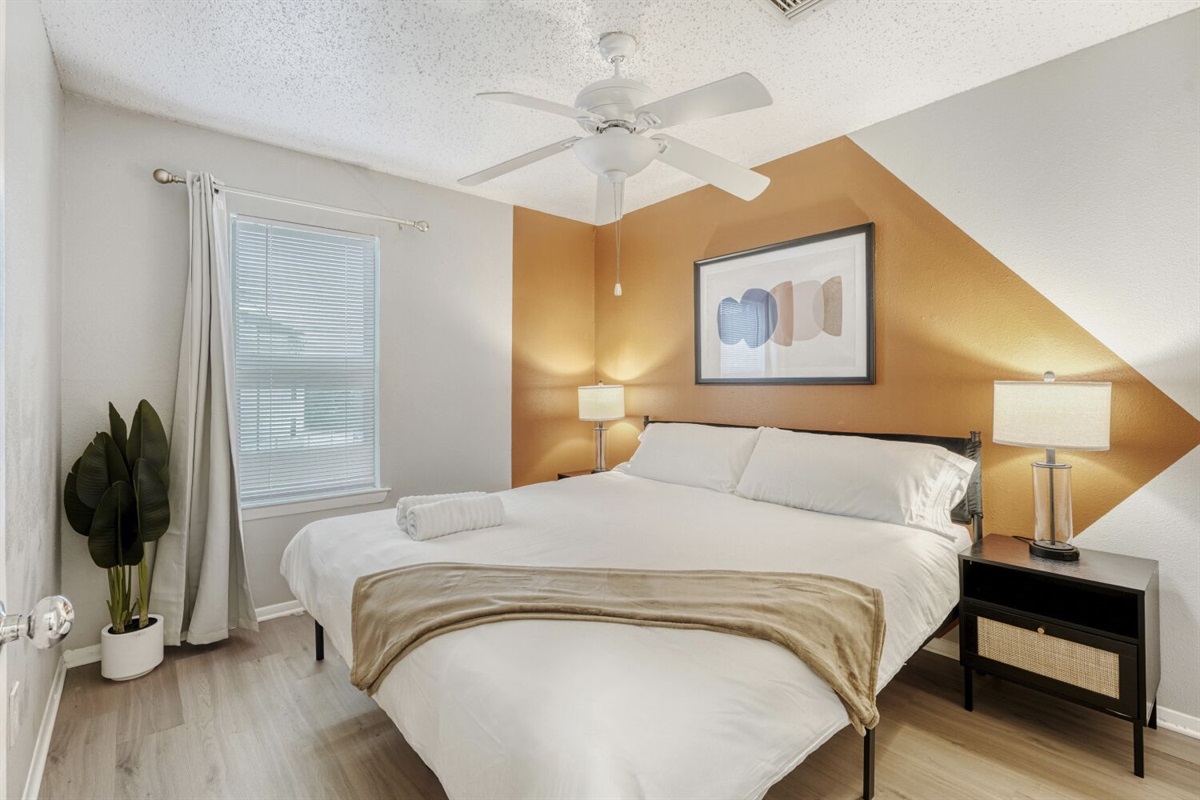 Cozy bedroom with modern accents and warm, inviting lighting.